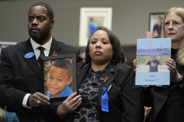 FILE - Todd and Mia Minor, both of Accokeek, Md., left, hold a photo of their son, Matthew Minor as they attend a Senate Judiciary Committee hearing with the heads of social media platforms on Capitol Hill in Washington, Jan. 31, 2024, on child safety. The Minor's son, Matthew Minor, died after a TikTok "choking challenge" in 2019. Florida is on the verge of passing one of the nation’s most restrictive bans on minors’ use of social media. The state Senate passed a bill Thursday, Feb. 22, 2024 that would keep children under the age of 16 off popular platforms regardless of parent approval. (AP Photo/Susan Walsh, file)