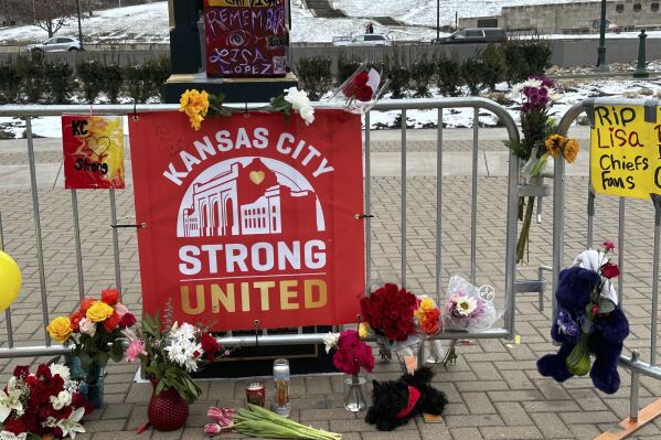 Flowers, signs and other items are gathered in front of Union Station on Friday, Feb. 16, 2024, in Kansas City, Mo. The memorial is for the victims of a shooting that took place following a Kansas City Chiefs Super Bowl victory rally on Wednesday. (AP Photo/Nick Ingram)