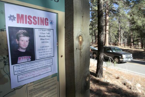 FILE - In this Nov. 26, 2012, file photo, a missing poster of 13-year-old Dylan Redwine hangs on a trail head sign next to Vallecito Reservoir in Vallecito, Colo. Opening statements are expected sometime Monday, June 21, 2021, in the delayed trial of a man accused of killing his 13-year-old son in southwest Colorado nearly a decade ago. Dylan Redwine disappeared during a court ordered Thanksgiving visit in 2012 and his remains were later found. (Shaun Stanley/The Durango Herald via AP, File)