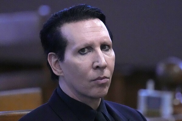 FILE - Musical artist Marilyn Manson, whose legal name is Brian Hugh Warner, waits for the judge to arrive in Belknap Superior Court,Monday, Sept. 18, 2023, in Laconia, N.H. Manson, who was sentenced to community service for blowing his nose on a videographer at a 2019 concert in New Hampshire, recently completed his time at an organization that provides meeting space for Alcoholics Anonymous and Al-Anon, according to court paperwork. (AP Photo/Charles Krupa, File)