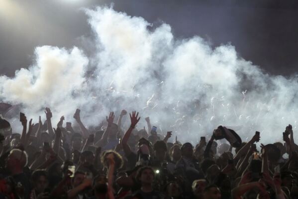 PSG supporters celebrate during the Champions League final soccer match between Paris Saint-Germain and Inter Milan, Saturday, May 31, 2025 at the Parc des Princes stadium in Paris. (AP Photo/Michel Euler)