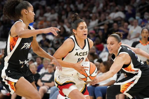 Las Vegas Aces' Kelsey Plum (10) drives to the basket between Phoenix Mercury's Skyler Diggins-Smith, left, and Diana Taurasi, right, during the first half of a WNBA basketball game Friday, May 6, 2022, in Phoenix. (AP Photo/Darryl Webb)
