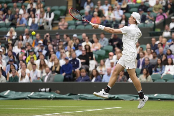 Denis Shapovalov of Canada plays a forehand return to Ben Shelton United States during their third round match at the Wimbledon tennis championships in London, Saturday, July 6, 2024. (AP Photo/Alberto Pezzali)