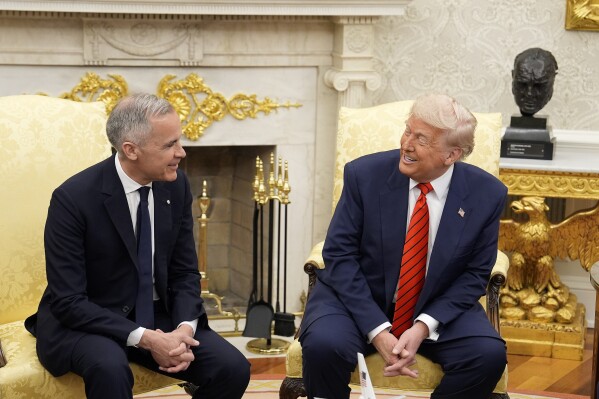 Canada Prime Minister Mark Carney and U.S. President Donald Trump engage in a meeting at the White House in Washington, Tuesday, May 6, 2025. (Adrian Wyld/The Canadian Press via AP)