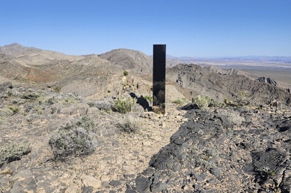 This photo provided by Las Vegas Metropolitan Police Department shows a monolith near Gass Peak, Nevada on Sunday, June 16, 2024. Jutting out of the rocks on a remote mountain peak near Las Vegas, the glimmering rectangular prism's reflective surface imitates the vast desert landscape surrounding the mountain peak where it has been erected. (Las Vegas Metropolitan Police Department via AP)