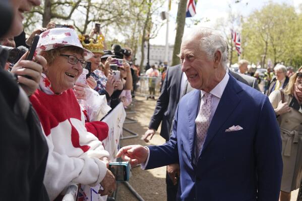Britain's King Charles III greets wellwishers outside Buckingham Palace, in London, Friday, May 5, 2023 a day before his coronation takes place at Westminster Abbey. (James Manning/PA via AP)