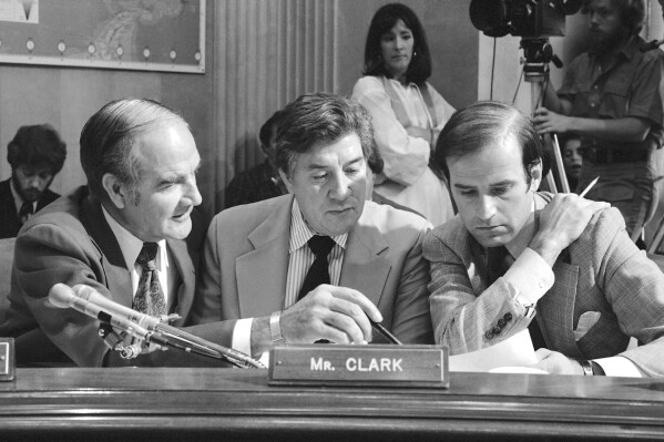 FILE - Three members of the Senate Foreign Relations committee, from left, Sen. George Stanley McGovern, D-S.D., Sen. Dick Clark, D-Iowa, and Sen. Joseph Biden, Jr., D-Del., huddle in Washington on May 12, 1978, as the panel prepares to vote on the proposed sale of U.S. warplanes to countries in the Middle East. Former U.S. Sen. Dick Clark, a Democrat who served a single term representing Iowa in the 1970s and was known for his work in global affairs, particularly in the aftermath of the Vietnam War, died Wednesday, Sept. 20 2023, at his home in Washington, his daughter Julie Clark Mendoza said. He was 95. (AP Photo/File)