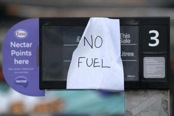 A sign indicating that fuel has run out is seen at a petrol station in Manchester, Monday, Sept. 27, 2021. British Prime Minister Boris Johnson is said to be considering whether to call in the army to deliver fuel to petrol stations as pumps ran dry after days of panic buying. ( AP Photo/Jon Super)