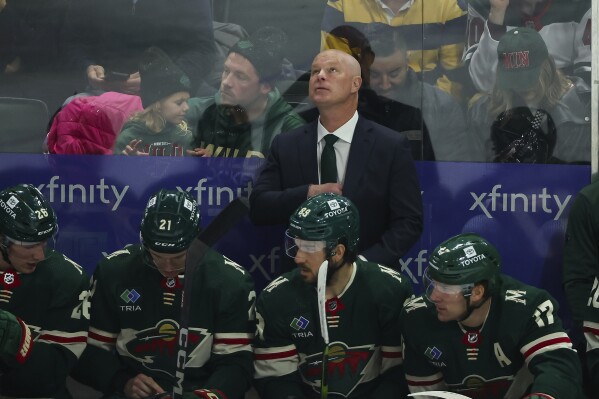 Minnesota Wild head coach John Hynes looks up to the scoreboard during the first period of an NHL hockey game against the St. Louis Blues, Tuesday, Nov. 28, 2023, in St Paul, Minn. (AP Photo/Matt Krohn)