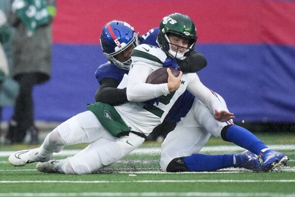 New York Jets quarterback Zach Wilson (2) is tackled by New York Giants outside linebacker Kayvon Thibodeaux (5) during the second half of an NFL football game, Sunday, Oct. 29, 2023, in East Rutherford, N.J. (AP Photo/Frank Franklin II)