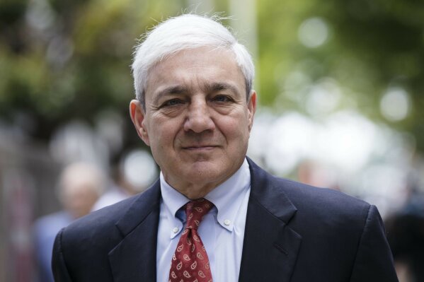 
              FILE - In this June 2, 2017, file photo, former Penn State President Graham Spanier departs after his sentencing hearing at the Dauphin County Courthouse in Harrisburg, Pa. A federal judge on Tuesday, April 30, 2019 has thrown out Spanier's child-endangerment conviction, less than a day before he was due to turn himself in to jail. (AP Photo/Matt Rourke, File)
            