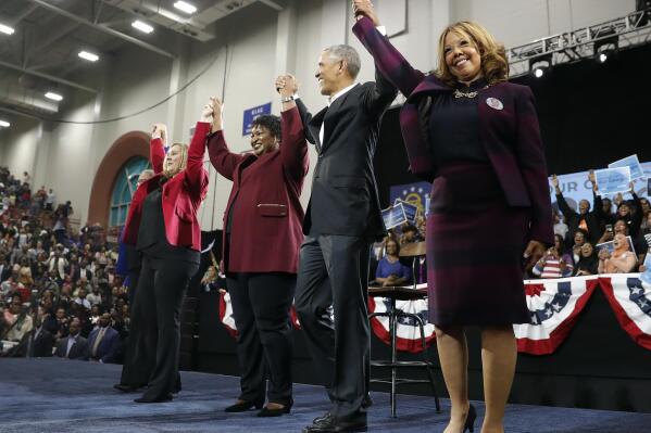 Former President Barack Obama stands with Georgia Democratic candidate for Lt. Gov. Sarah Riggs Amico, left, gubernatorial candidate Stacey Abrams and congressional candidate Lucy McBath, right, after speaking at during a campaign rally at Morehouse College Friday, Nov. 2, 2018, in Atlanta. (AP Photo/John Bazemore)