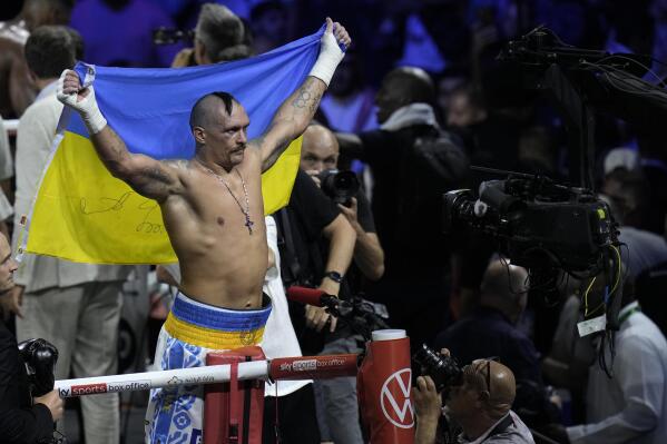 Ukraine's Oleksandr Usyk celebrates after beating Britain's Anthony Joshua to retain his world heavyweight title at King Abdullah Sports City in Jeddah, Saudi Arabia, Sunday, Aug. 21, 2022. (AP Photo/Hassan Ammar)