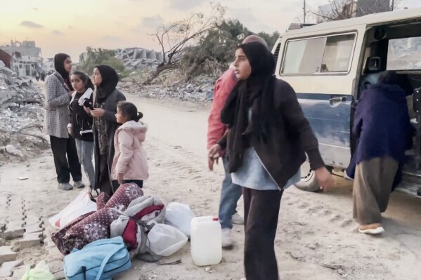 In this image made from an Associated Press video, Ne'man Abu Jarad and his family return to their home in Beit Lahiya, Gaza Strip, on Monday, Jan. 29, 2025, for the first time since the war between Hamas and Israel began. (AP Photo)