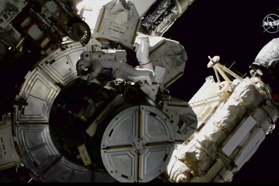 In this image provided by NASA shows NASA astronauts Victor Glover and Mike Hopkins on a spacewalk outside the International Space Station on Saturday, March 13, 2021.  The astronauts are rearranging space station plumbing and tackling other odd jobs. The work should have been completed a week ago, but power upgrades took longer than expected. (NASA via AP)