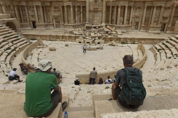 Tourists visit Roman ruins in Palmyra, Syria, Tuesday, May 11, 2023. Palmyra was captured by the Islamic State militants in 2015, who blew up some of the most iconic structures. (AP Photo/Omar Sanadiki)