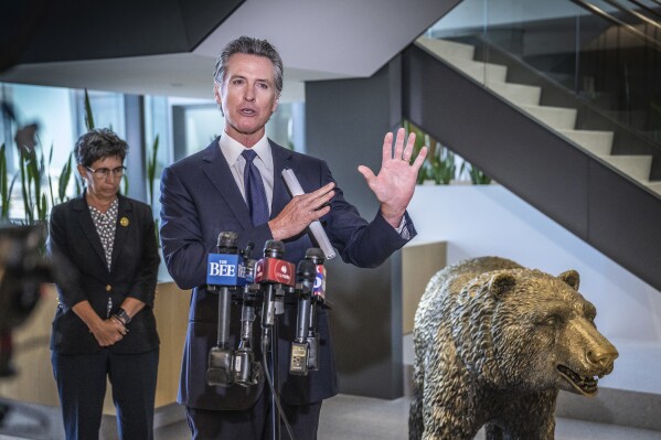 California Gov. Gavin Newsom gestures during a press conference at his swing space office after meeting a coalition of behavioral health reform leaders and local elected officials in Sacramento, Calif., on Wednesday, July 12, 2023. Newsom stepped in Wednesday to help revive a bill that would increase penalties for child trafficking. Newsom told reporters he was surprised the bill failed to pass an Assembly committee. (Hector Amezcua/The Sacramento Bee via AP)