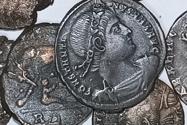 A picture made available by the Italian Culture Minister showing some of the discovered ancient bronze coins. A diver's spotting something metallic not far from the Sardinian coast has led to the discovery of tens of thousands of ancient bronze coins. Italy's culture ministry said on Saturday, Nov. 4, 2023, that the diver alerted authorities, who sent divers assigned to an art protection squad along with others from the ministry's undersea archaeology department. Found in sea grass, not far from the northeast shore of the Mediterranean island were the coins dating from the first half of the 4th century. (Italian Culture Ministry Via AP)