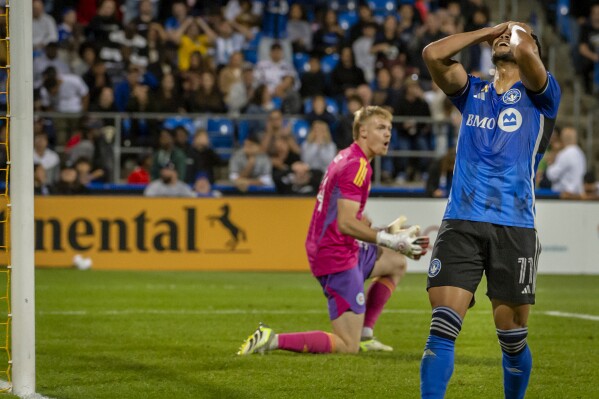 CF Montreal's Ariel Lassiter (11) reacts after missing a shot on the net of Chicago Fire's Chris Brady during the second half of an MLS soccer match in Montreal, Saturday, Sept. 16, 2023. (Peter McCabe/The Canadian Press via AP)