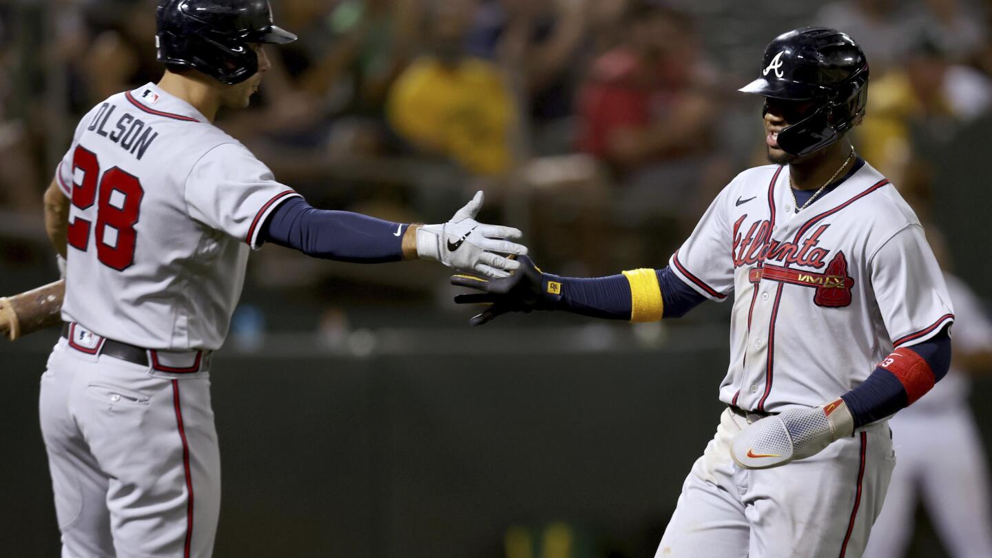 Austin Riley of the Atlanta Braves is congratulated by Matt Olson