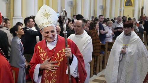 FILE - Cardinal Matteo Zuppi, head of the CEI (Italian Conference of Bishops), welcomes parishioners after celebrating Mass at the Cathedral of the Immaculate Conception in Moscow, Thursday, June 29, 2023. Pope Francis’ peace envoy was travelling to Washington on Monday, July 17 in hopes of promoting peace initiatives for Ukraine and supporting humanitarian operations, especially concerning children, the Vatican said. Cardinal Matteo Zuppi’s visit, which lasts through Wednesday, follows his recent mission to Moscow and an earlier stop in Kyiv, where he met with President Volodymyr Zelenskyy. (AP Photo/Alexander Zemlianichenko, file)