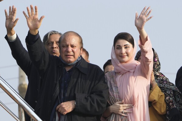 Pakistan's former Prime Minister Nawaz Sharif, center, and his daughter Maryam Nawaz, right, waves to their supporters as they arrive to address an election campaign rally in Hafizabad, Pakistan, Thursday, Jan. 18, 2024. More than 120 million voters in Pakistan get to elect a new parliament on Thursday. The elections are the twelfth in the country's 76-year history, which has been marred by economic crises, military takeovers and martial law, militancy, political upheavals and wars with India. (AP Photo/K.M. Chaudary)