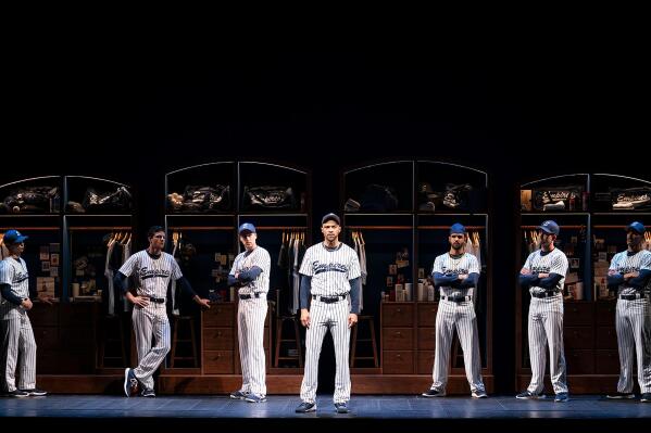 This image released by Polk & Co. shows Jesse Williams, center, during a performance of the Broadway revival of the baseball-themed "Take Me Out," in New York. (Joan Marcus/Polk & Co., via AP)