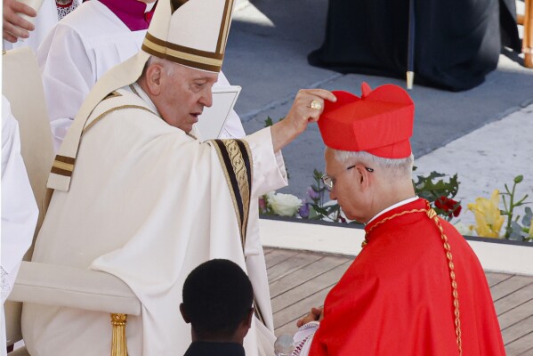 Newly elected Cardinal Robert Francis Prevost, Prefect of the Dicastery for Bishops, right, receives his biretta from Pope Francis as he is elevated in St. Peter's Square at The Vatican, Sept. 30, 2023. (AP Photo/Riccardo De Luca, file)