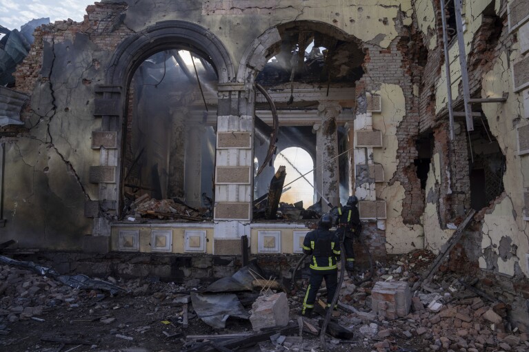 FILE - Firefighters put out the fire a railway station after Russians hit in Kostiantynivka, Donetsk region, Ukraine, Sunday, Feb. 25, 2024. A woman was wounded and a railway station, shops and residential houses were badly damaged amid heavy bombing. (AP Photo/Alex Babenko, File)