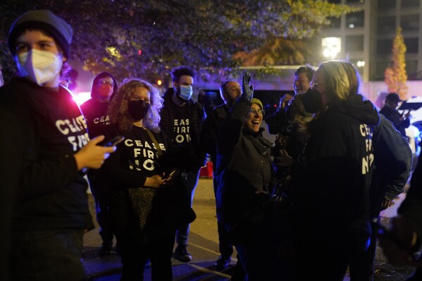 Protesters cheer outside the Democratic National Committee head office Wednesday, Nov. 15, 2023, in Washington. (AP Photo/Nathan Howard)