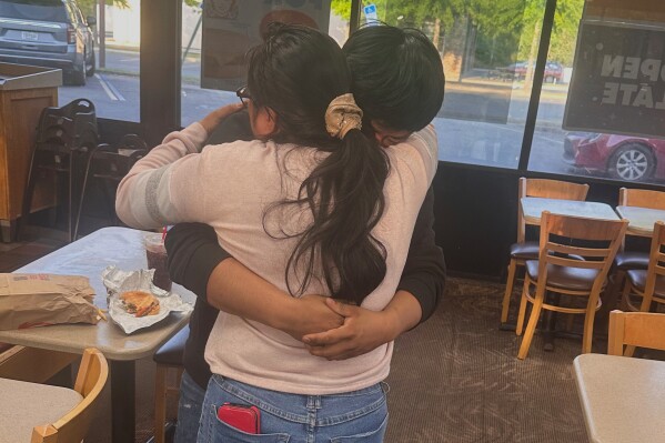 Juan Carlos Lopez Gomez, 20, a U.S. citizen, hugs his mother in Tallahassee, Fla., after his April 17, 2025 release from jail where he was being held by federal immigration authorities. (Thomas Kennedy via AP)