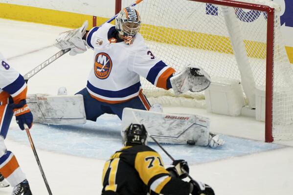 New York Islanders goaltender Ilya Sorokin (30) makes a save against a shot by Pittsburgh Penguins center Evgeni Malkin (71) during the first period of an NHL hockey game in Pittsburgh, Monday, Feb. 20, 2023. (AP Photo/Matt Freed)