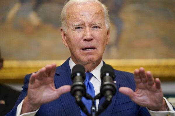 President Joe Biden, center, delivers remarks on recovery efforts for the Maui wildfires and the response to Hurricane Idalia, in the Roosevelt Room of the White House, Wednesday, Aug. 30, 2023, in Washington. (AP Photo/Evan Vucci)