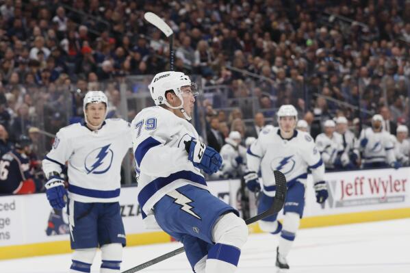 Tampa Bay Lightning's Ross Colton, center, celebrates his goal against the Columbus Blue Jackets during the first period of an NHL hockey game Friday, Oct. 14, 2022, in Columbus, Ohio. (AP Photo/Jay LaPrete)