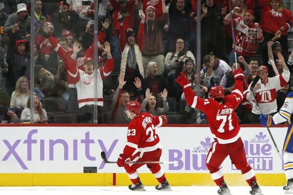 Detroit Red Wings right wing Lucas Raymond (23) celebrates his game-winning goal with center Dylan Larkin (71) during overtime of an NHL hockey game Saturday against the Buffalo Sabres, Nov. 27, 2021, in Detroit. (AP Photo/Duane Burleson)