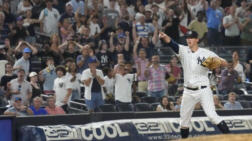 New York Yankees third baseman DJ LeMahieu, right, reacts after tagging Kansas City Royals' Drew Waters for the final out in the ninth inning of a baseball game, Friday, July 21, 2023, in New York. (AP Photo/Mary Altaffer)