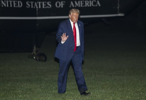 President Donald Trump waves while walking from Marine One on the South Lawn of the White House, Friday, July 31, 2020, in Washington. Trump is returning from Florida. (AP Photo/Alex Brandon)