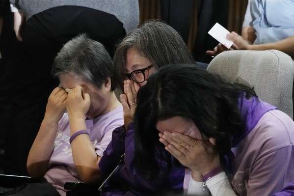 Bereaved family members of the victims of the Halloween crush in 2022 react at the National Assembly in Seoul, South Korea, Thursday, May 2, 2024. South Korea's parliament on Thursday approved legislation mandating a new, independent investigation into the 2022 Halloween crush in Seoul that killed 159 people. (AP Photo/Ahn Young-joon)