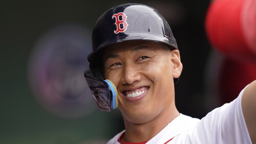 Boston Red Sox's Masataka Yoshida celebrates in the dugout after scoring on a double by Christian Arroyo in the sixth inning of a baseball game against the Oakland Athletics, Sunday, July 9, 2023, in Boston. (AP Photo/Steven Senne)