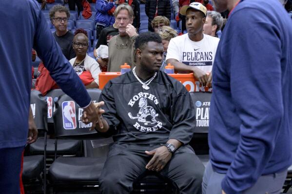 New Orleans Pelicans forward Zion Williamson sits on the bench as teammates pass by after the Pelicans lost to the Oklahoma City Thunder in an NBA basketball play-in tournament game in New Orleans, Wednesday, April 12, 2023. (AP Photo/Matthew Hinton)