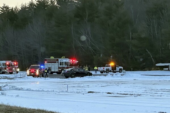 In this image provided by Moultonborough Fire Chief David Bengtson., Authorities respond to a small plane crash at the Moultonborough Airport in Moultonborough, N.H., Sunday, Feb. 25, 2024. The single-engine plane was found near some trees. No injuries were reported and authorities are investigating. (Moultonborough Fire Chief David Bengtson via AP)