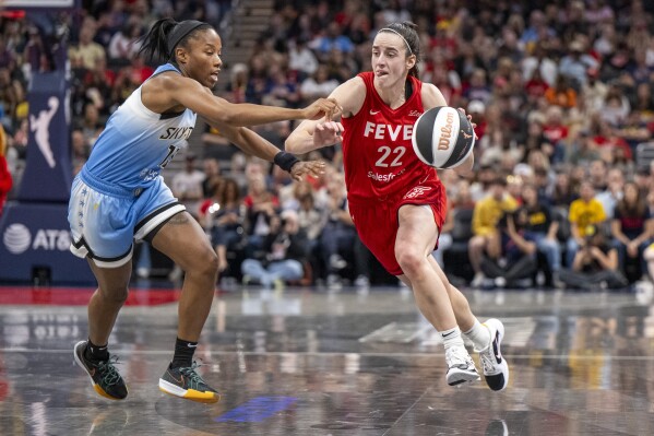 Indiana Fever guard Caitlin Clark (22) makes a move around the defense of Chicago Sky guard Lindsay Allen, left, during a WNBA basketball game Saturday, June 1, 2024, in Indianapolis. (AP Photo/Doug McSchooler)