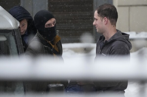 Wall Street Journal reporter Evan Gershkovich, right, is escorted from the Lefortovsky court in Moscow, Russia, Friday, Jan. 26, 2024. Evan Gershkovich, a Wall Street Journal reporter who was detained on espionage charges, lost an appeal Friday against his arrest, meaning he will stay in jail until the end of March, Russian state news agencies reported. The hearing took place behind closed doors because authorities say details of the criminal case against the American journalist are classified. (AP Photo/Alexander Zemlianichenko)