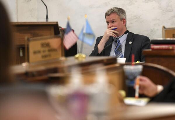 FILE - South Dakota Attorney General Jason Ravnsborg rests his hand on his face while listening to opening remarks by the defense at his impeachment trial on Tuesday, June 21, 2022, at the South Dakota State Capitol in Pierre, S.D. The now former Attorney General Ravnsborg, in his first public comments since being removed from office last week, appeared before a state ethics board Monday, June 27, 2022, to press for an investigation of fellow Republican Gov. Kristi Noem, the person he blames for his impeachment over his conduct surrounding a 2020 fatal car crash. (Erin Woodiel/The Argus Leader via AP File)