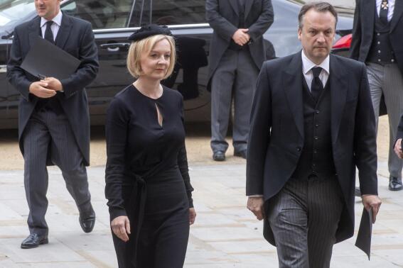 British Prime Minister Liz Truss and her husband Hugh O'Leary arrive for the funeral service of Queen Elizabeth II at Westminster Abbey in central London, Monday Sept. 19, 2022. The Queen, who died aged 96 on Sept. 8, will be buried at Windsor alongside her late husband, Prince Philip, who died last year. (Geoff Pugh/Pool via AP)