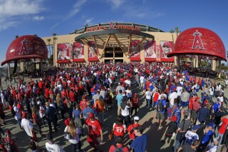 FILE - Fans line up outside Angel Stadium of Anaheim for an opening day baseball game between the Los Angeles Angels and the Chicago Cubs in Anaheim, Calif., on April 4, 2016. Harish Singh Sidhu, the former mayor of the Southern California city of Anaheim has agreed to plead guilty to obstructing an FBI corruption investigation into the $150 million sale of Angel Stadium to the owner of the Major League Baseball team, federal prosecutors announced Wednesday, Aug. 16, 2023. (AP Photo/Mark J. Terrill, File)