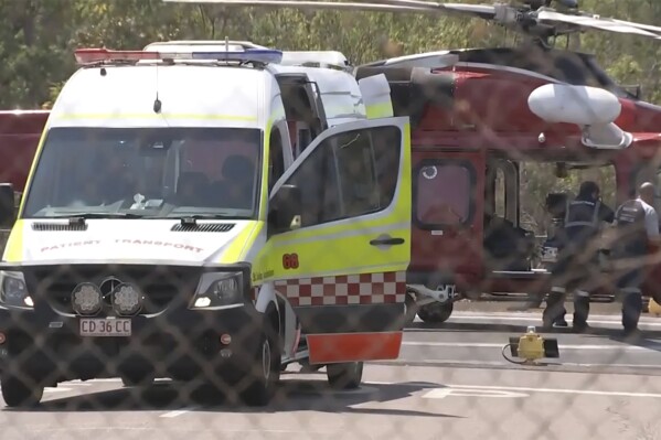 This image made from video shows a helicopter and ambulance involved in rescue mission, following an aircraft crash, in Darwin, Australia, Sunday, Aug. 27, 2023. Three United States military personnel were taken to a hospital, one with critical injuries, after a U.S. aircraft crashed on a north Australian island Sunday during a multination military exercise, officials said. (AuBC via AP)