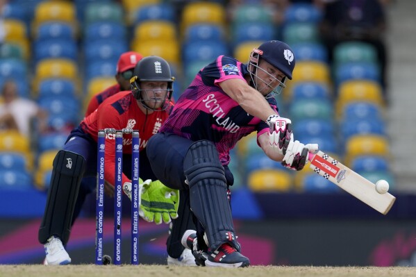 Scotland's George Munsey plays a shot from a delivery of England's Moeen Ali during an ICC Men's T20 World Cup cricket match at Kensington Oval in Bridgetown, Barbados, Tuesday, June 4, 2024. (AP Photo/Ricardo Mazalan)