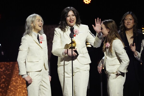 Phoebe Bridgers, from left, Lucy Dacus and Julien Baker, of boygenius accept the award for best rock performance "Not Strong Enough" during the 66th annual Grammy Awards on Sunday, Feb. 4, 2024, in Los Angeles. (AP Photo/Chris Pizzello)