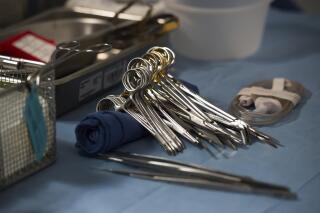 FILE - Surgical instruments and supplies lay on table during a kidney transplant surgery at MedStar Georgetown University Hospital in Washington D.C., Tuesday, June 28, 2016. The U.S. transplant system isn’t fair enough and needs an overhaul to stop wasting organs and give more patients an equal chance at the life-saving surgery, says an influential scientific advisory panel.  (AP Photo/Molly Riley, File)